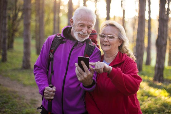 senior couple check the status of their insurance claim with a smartphone app